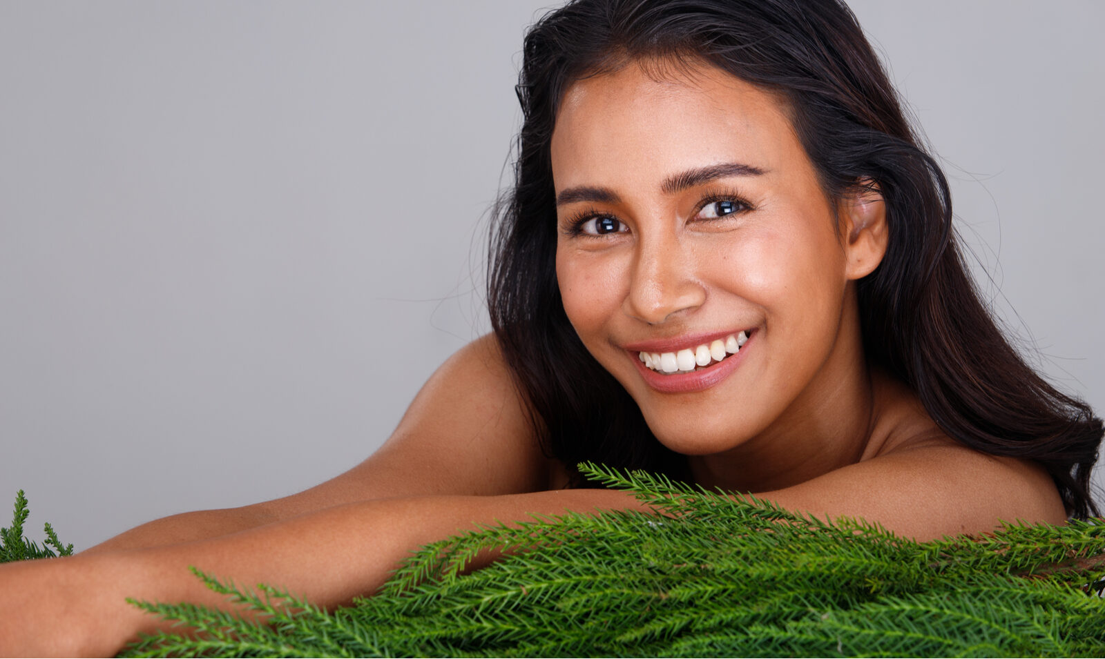 Woman with radiant, even skin after medical aesthetic treatment at Olive Irvine Medical Aesthetic Center